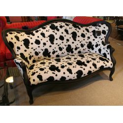 Victorian finger carved ebonized walnut sofa with cow print upholstery