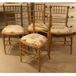 Set of four giltwood ballroom side chairs with newly upholstered seats.